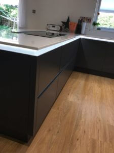 Handleless kitchen in a matt graphite door fitted with Neff appliances